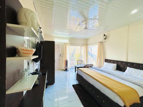 a bedroom with a large bed in a room at IN APPLE ESTATE KANATAL - Himalayan View Resort with Courteous Staff in Kanatal