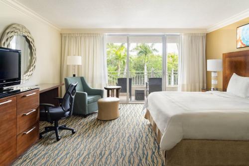 a hotel room with a bed and a television at Marriott Sanibel Harbour Resort & Spa in Fort Myers