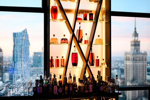 a display of bottles on a shelf in a window at Warsaw Presidential Hotel in Warsaw