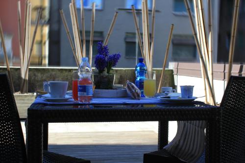 a table with plates and bottles of water on it at SoloSonno in Lecco