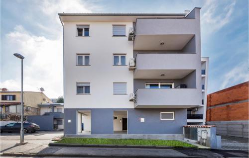 a white apartment building with a balcony at Cozy Apartment In Pula With Wifi in Pula