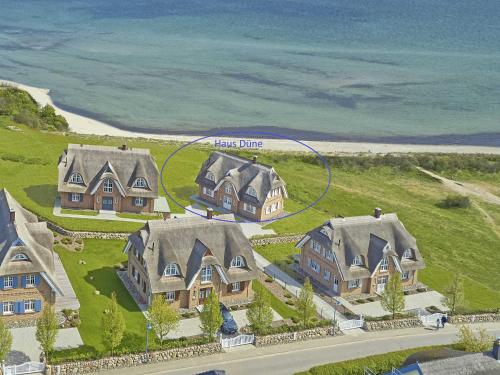 an aerial view of a home with a large house at Strandhaus 6 "Düne" in Lobbe mit Meerblick, Kamin, Sauna in Lobbe