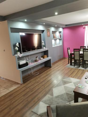 a living room with a flat screen tv on a wall at Apartament u Wioli in Okleśna