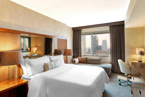 a hotel room with a large bed and a desk at The Westin New York at Times Square in New York