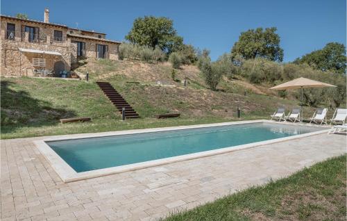 a swimming pool in front of a house at Nice Home In Lugnano In Teverina in Lugnano in Teverina