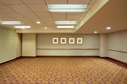 a large room with three pictures on the wall at The Westin New York at Times Square in New York