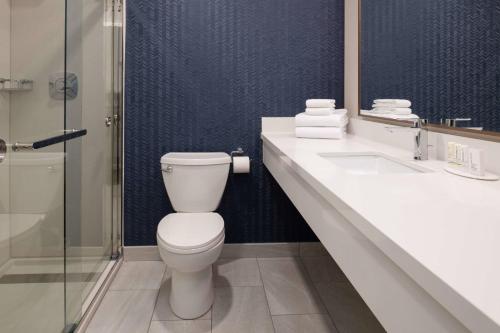 a bathroom with a toilet and a sink and a shower at Fairfield Inn Spokane Downtown in Spokane