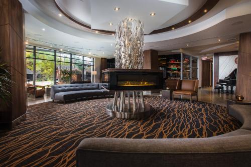 a living room with a couch and a fireplace at Delta Hotels by Marriott Waterloo in Waterloo