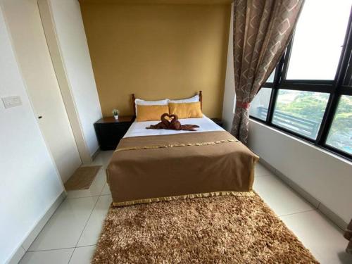 a bedroom with a bed with a teddy bear on it at CheeAyu@ Putrajaya IOI Resort in Putrajaya