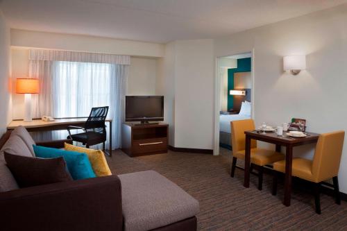 a living room with a couch and a dining room at Residence Inn by Marriott Toronto Markham in Markham