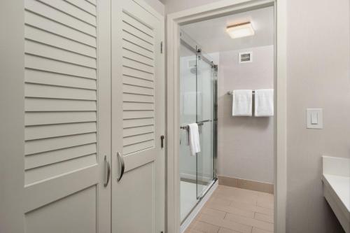 a bathroom with a shower and a glass door at Courtyard by Marriott Portland Beaverton in Beaverton