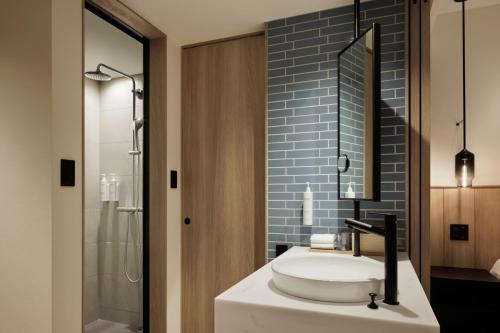 a bathroom with a sink and a shower at Fairfield by Marriott Okayama Hiruzen Highland in Maniwa