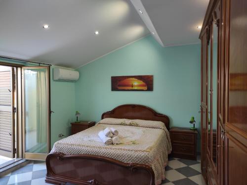 a bedroom with a bed with a stuffed animal on it at Casa Vacanza via Annarita Sidoti in Porto San Giorgio