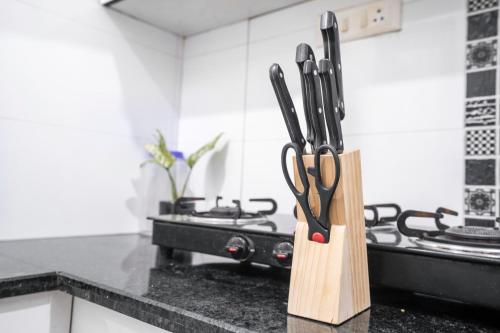 a kitchen counter with a knife block with scissors at Homlee-Heritage 2-Bed Room Apt near Pragati Maidan in New Delhi