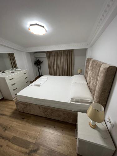 a bedroom with a large bed and a couch at House Elbasan city center 3 in Elbasan