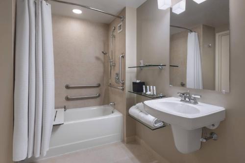 a bathroom with a sink and a toilet and a bath tub at Princeton Marriott at Forrestal in Princeton