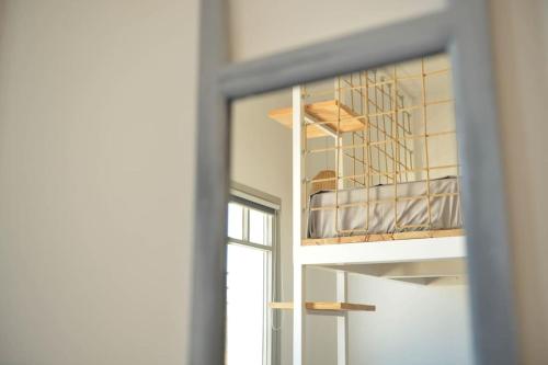 a reflection of a bunk bed in a mirror at Κατοικία Uppolis με θέα τα νησιά in Ano Syros