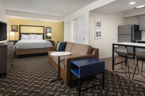 a hotel room with a bed and a couch at Residence Inn by Marriott San Francisco Airport San Mateo in San Mateo