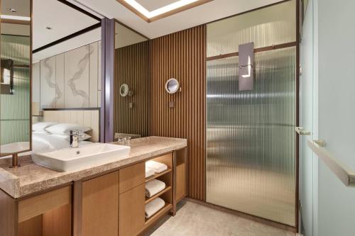 a bathroom with a sink and a shower at Daegu Marriott Hotel in Daegu