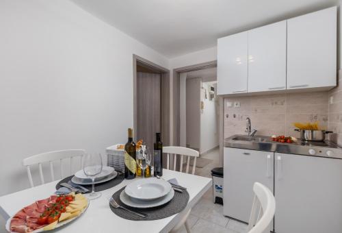 a kitchen with a table with a plate of food on it at Main View Apartment in Rijeka