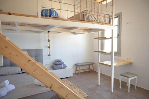 a room with a bunk bed and a staircase at Κατοικία Uppolis με θέα τα νησιά in Ano Syros