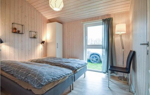 a bedroom with a bed and a large window at Gorgeous Home In Ejstrupholm With Wifi in Krejbjerg