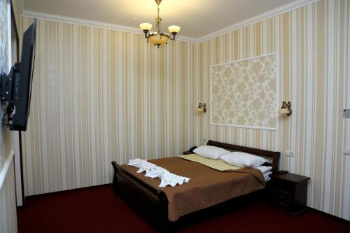 Säng eller sängar i ett rum på BeSt Hotel and Restaurant complex