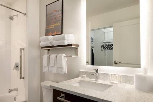 Baño blanco con lavabo y espejo en TownePlace Suites by Marriott Milwaukee Grafton en Grafton