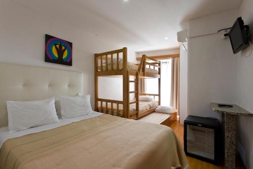 a bedroom with two bunk beds and a television at Braganca Oporto in Porto