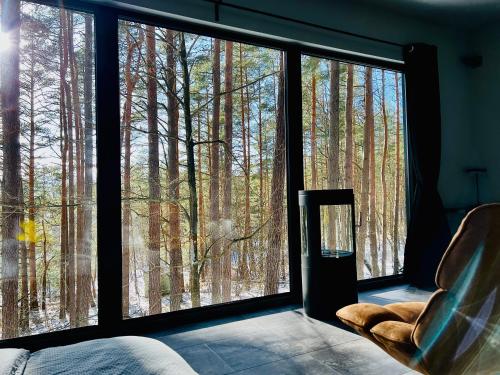 a room with a window looking out at a forest at Premium Forest Bungalow with Ofuro Tub in Luokesos Sen