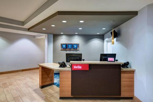 a lobby with a hello sign on a counter at TownePlace Suites by Marriott Monroe in Monroe