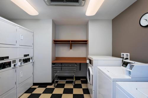 a laundry room with a washer and dryer and a clock at TownePlace Suites by Marriott Monroe in Monroe