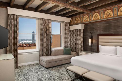 a bedroom with a bed and a chair and a window at Courtyard by Marriott San Diego Downtown in San Diego