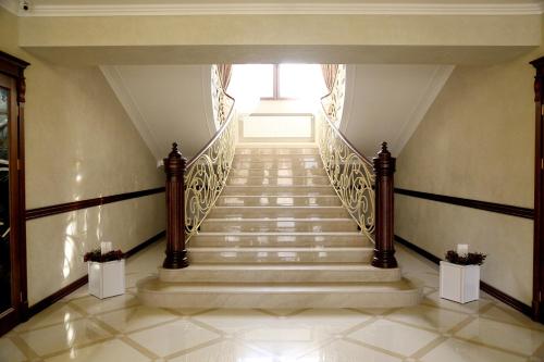a staircase in a house with a stair case at BeSt Hotel and Restaurant complex in Dunaivtsi
