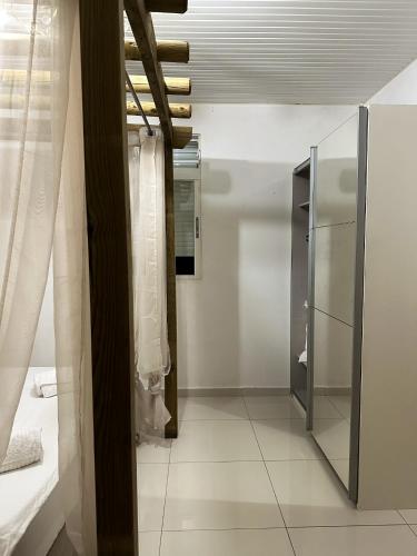 a bathroom with a glass cabinet and a mirror at Maison de 3 chambres avec piscine privee jardin clos et wifi a Sainte Rose in Sainte-Rose