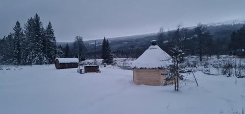 a small building with snow on it in a field at Villa Fregn in Ljørdal