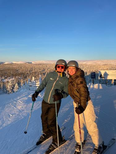 two people on skis on a snow covered slope at Villa Fregn in Ljørdal