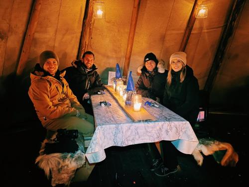 a group of people sitting around a table at Villa Fregn in Ljørdal