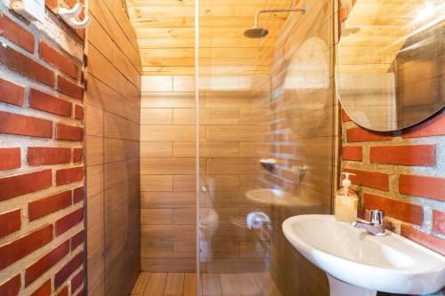 a bathroom with a sink and a glass shower at Hostal Ana in Santa Marta