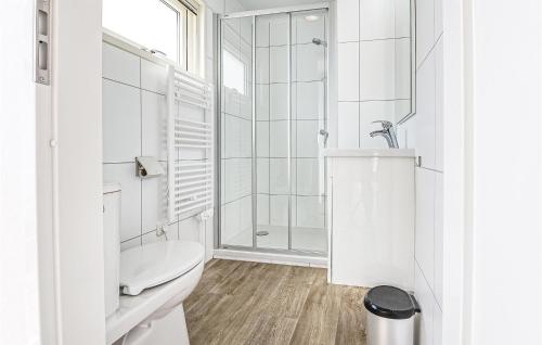a white bathroom with a shower and a toilet at Aqualiving in Aalsmeer