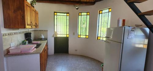 cocina con nevera y algunas ventanas en La Paisanita Gualeguaychú #lapaisanitagchu en Gualeguaychú