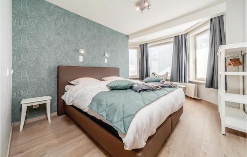 a bedroom with a bed with a green accent wall at Sea Level in De Panne