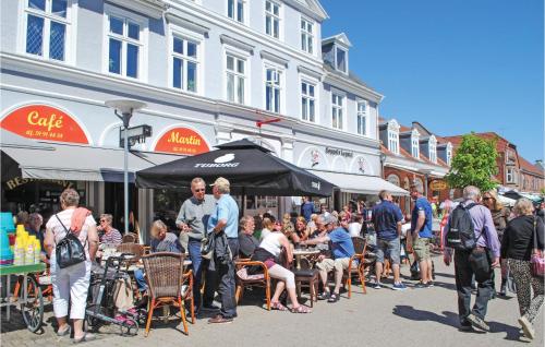 a crowd of people standing in a street with tables and chairs at Apartment Klint Strandvej Nykøbing Sj Vi in Højby