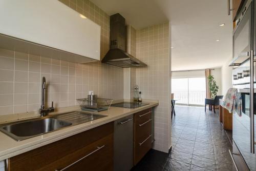 a kitchen with a sink and a counter top at apartment with amazing sea view in Burgau