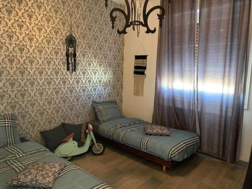 a bedroom with two beds and a scooter on the wall at gite des huskys in Tonnay-Charente