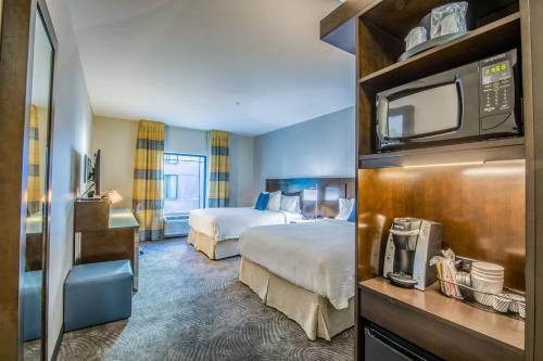 a hotel room with two beds and a microwave at Fairfield by Marriott Denver Downtown in Denver