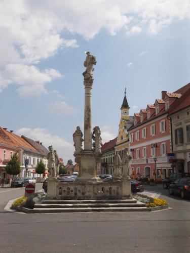 a fountain in the middle of a city street at Hotel Restaurant zum Schwan in Schwanberg