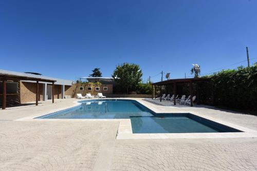 a large swimming pool with chairs at Camberland Resort & Spa Ramallo in Ramallo