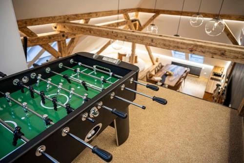 a pool table with cue sticks in a room at Vila Na Landeku in Ostrava