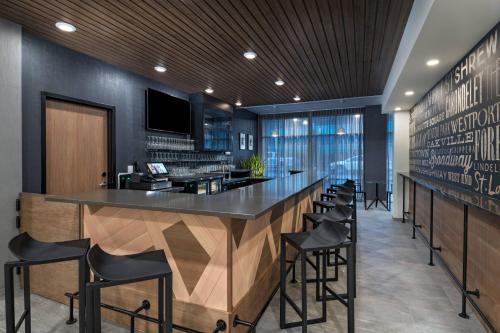 a bar in a restaurant with black walls and black stools at Fairfield Inn and Suites by Marriott St Louis Downtown in Saint Louis